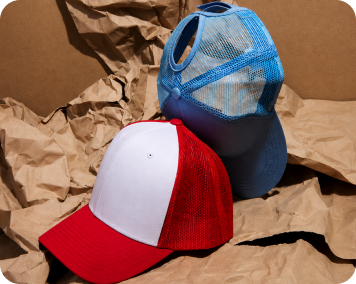Blue and red custom caps displayed on kraft paper